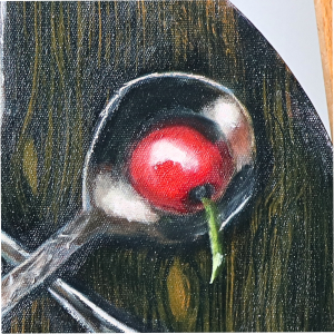 round still life silverware and cherries